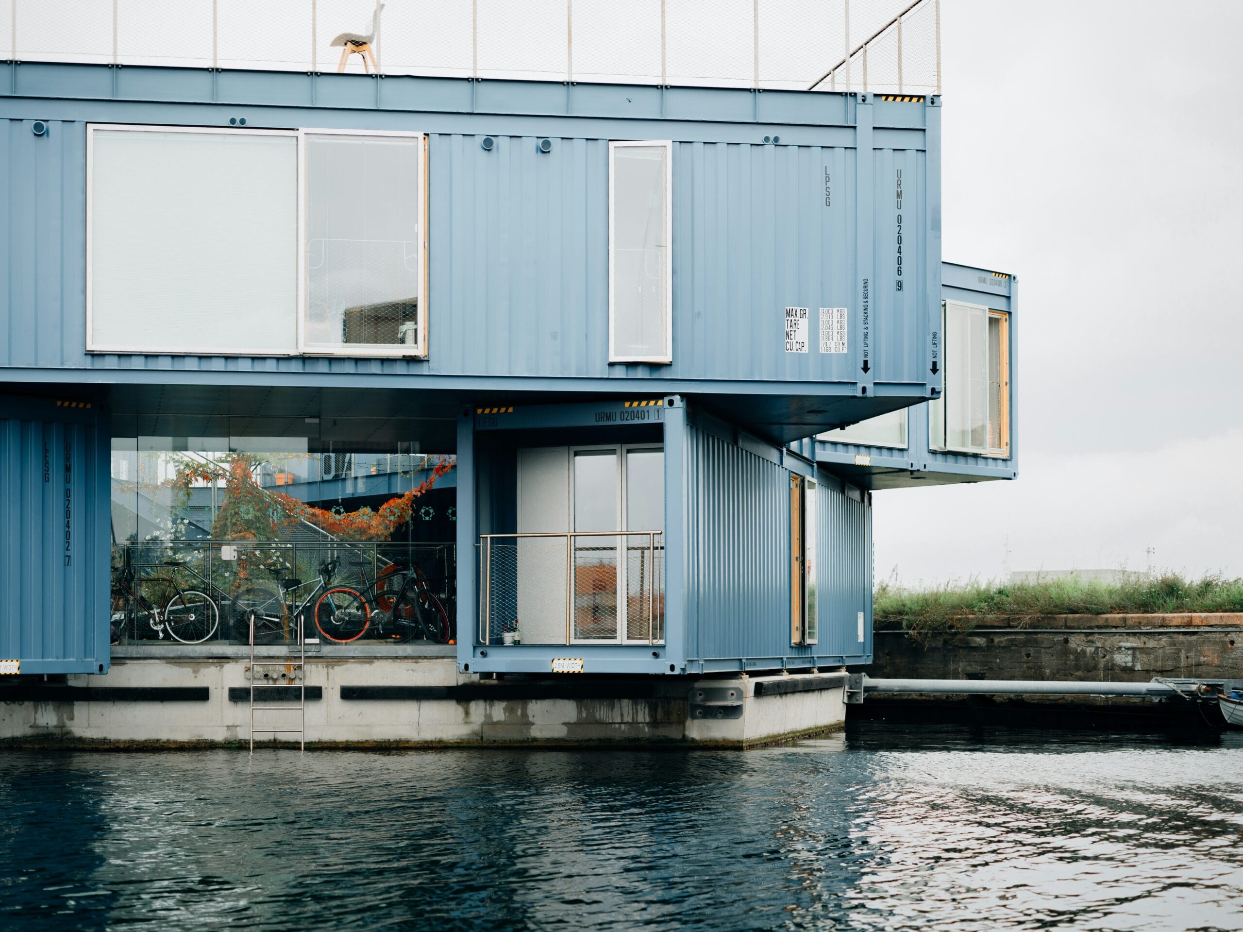 one of the uses of shipping container is container homes. This beautiful blue shipping container home is constructed using multiple containers that is stacked together.