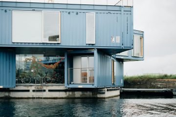 one of the uses of shipping container is container homes. This beautiful blue shipping container home is constructed using multiple containers that is stacked together.